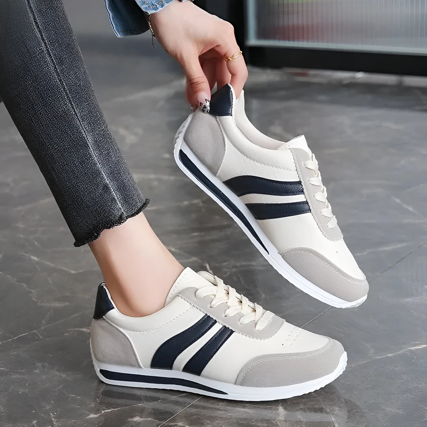 Red and blue lace-up running sneakers with soft rubber sole and mesh upper on white background