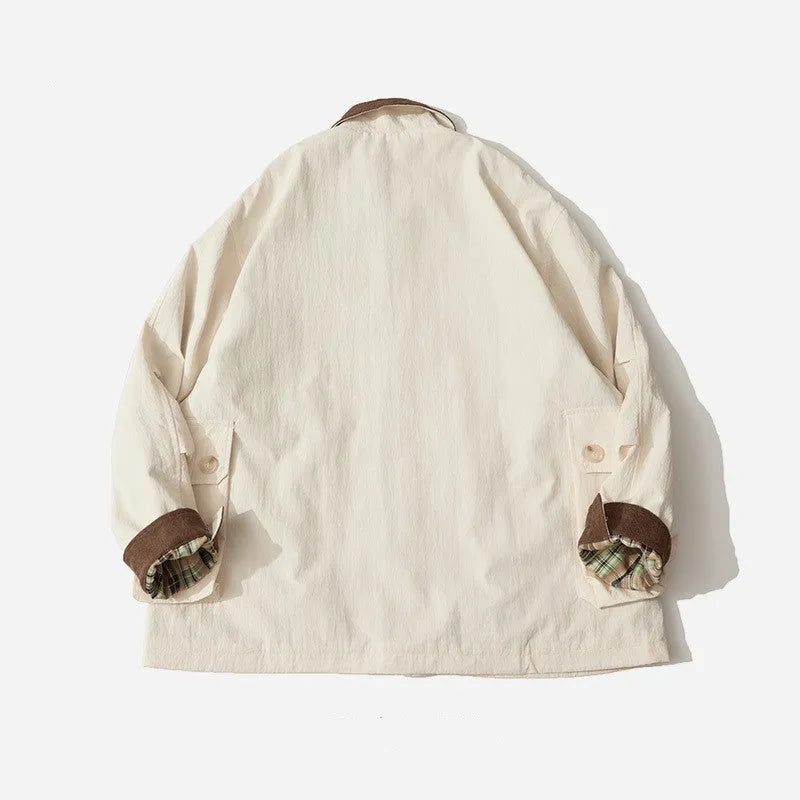 Green unisex casual jacket with contrast colour panels and side seam pockets on a model.