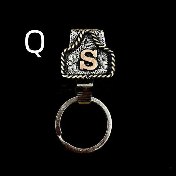 Handmade metal cow tag belt key holder keychain on a key ring, showing the metal loop and tag design.