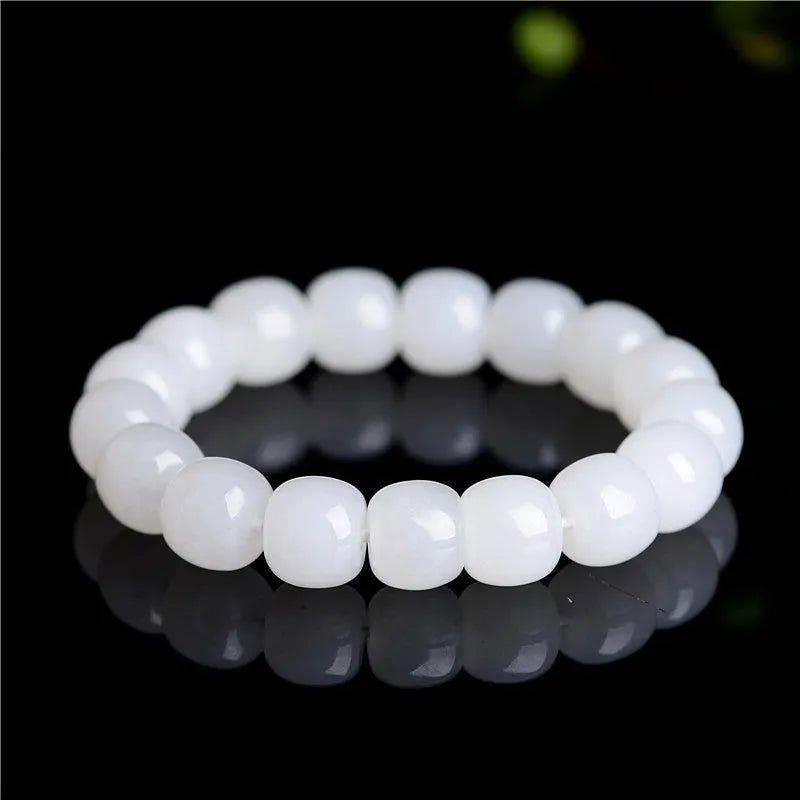 White Hetian jade barrel bead bracelet for men and women on a wrist, showing three bead size options.