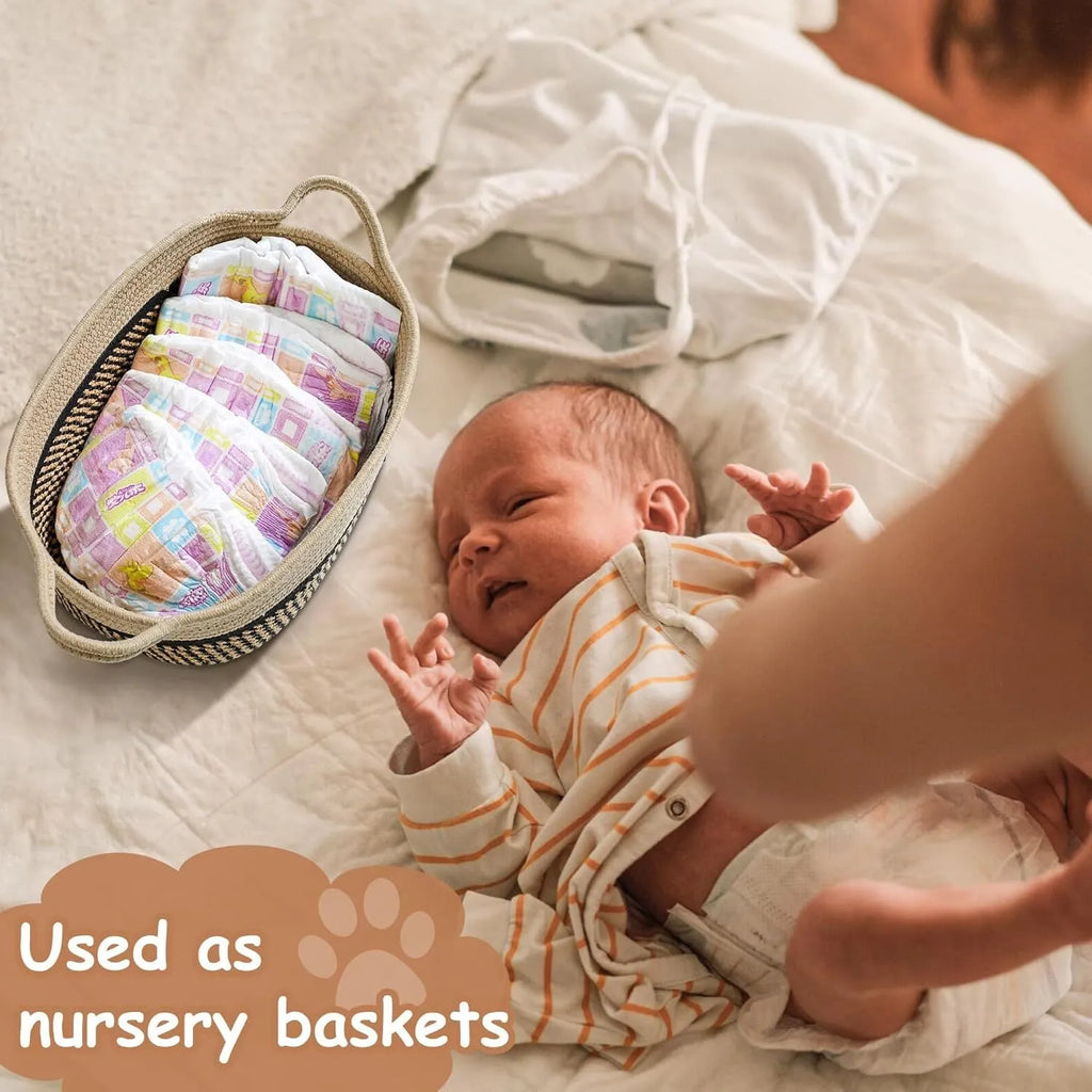 Light beige handmade woven cotton rope storage basket with a handle on a wooden surface.