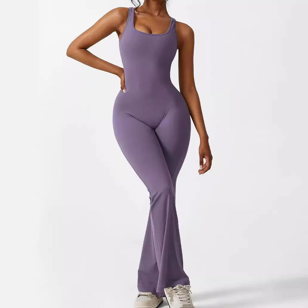 Woman wearing a sleeveless army green flare jumpsuit for yoga, showcasing the fashionable waist and trouser length.