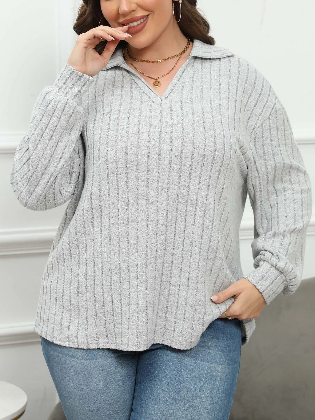 Women's plus size grey polo collar fleece shirt with lantern sleeves on a hanger