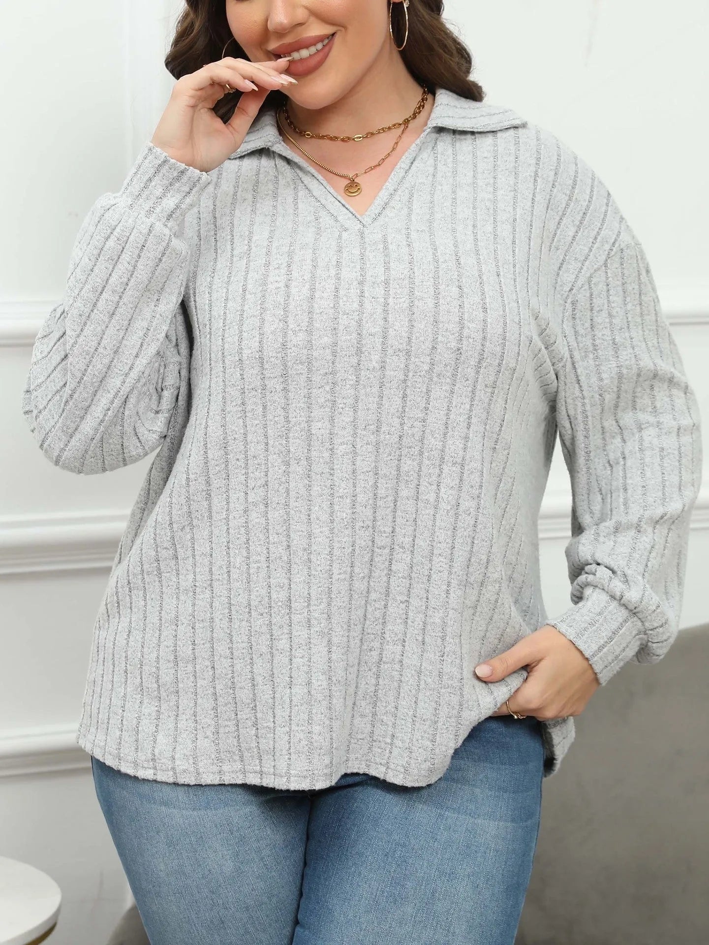 Women's plus size grey polo collar fleece shirt with lantern sleeves on a hanger