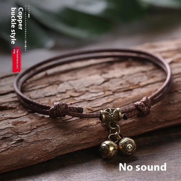 Small dog wearing adjustable nylon rope collar with brass bell in black, red or coffee colour