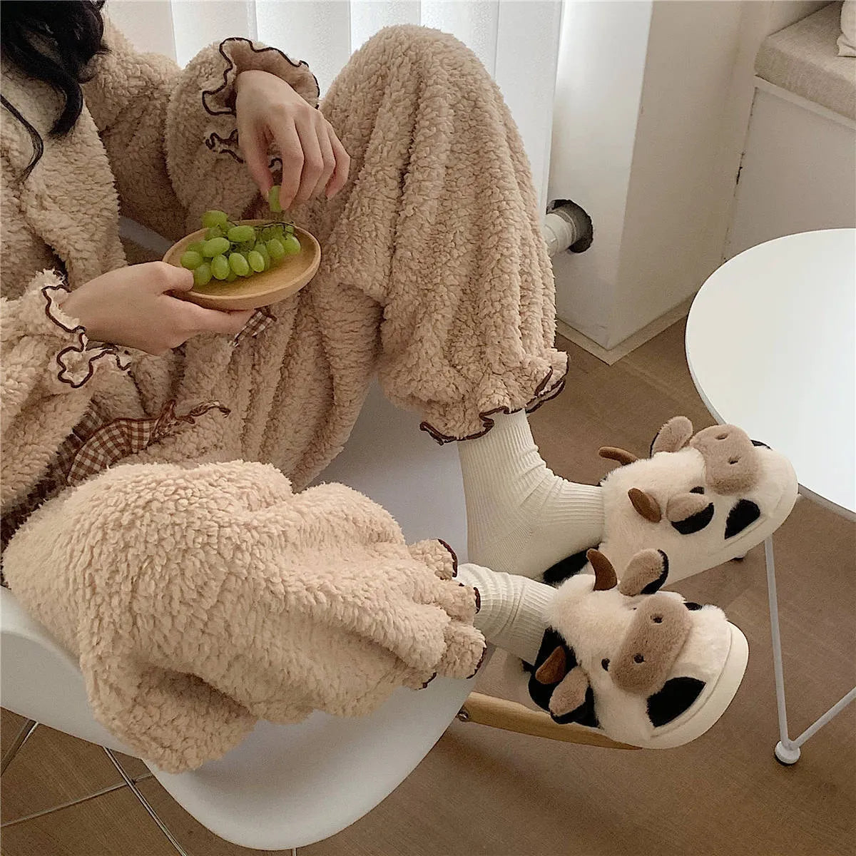 White cow design slippers with plush faux fur upper and textured non-slip sole