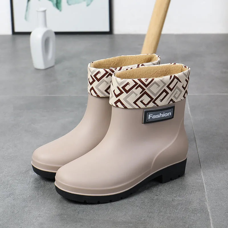 Women's black PVC rain boots with mid-calf height and low heel