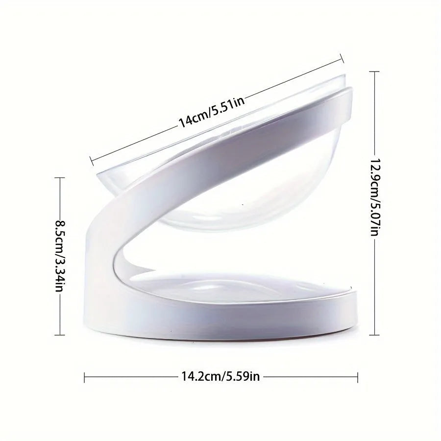 Clear plastic tilted cat food bowl on a flat surface