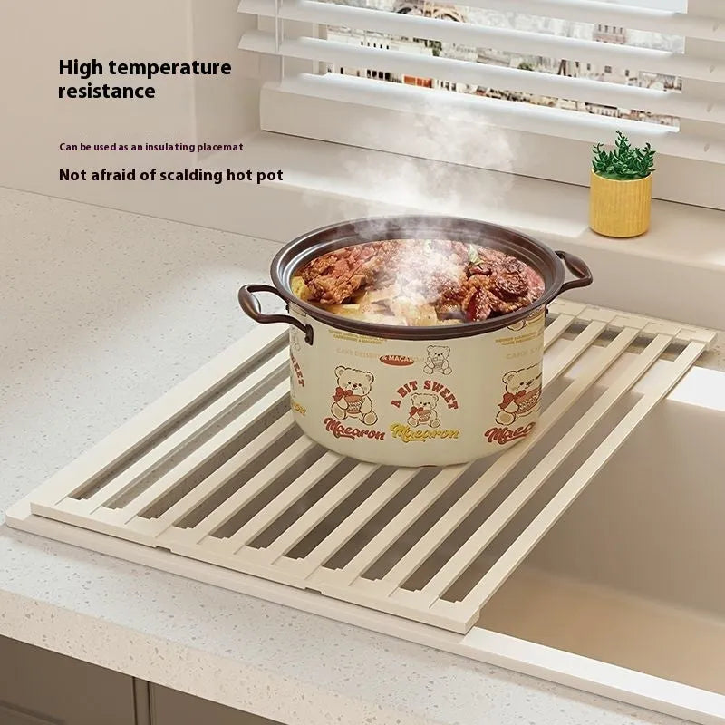 Milky white foldable stainless steel kitchen draining rack for dishes on a countertop