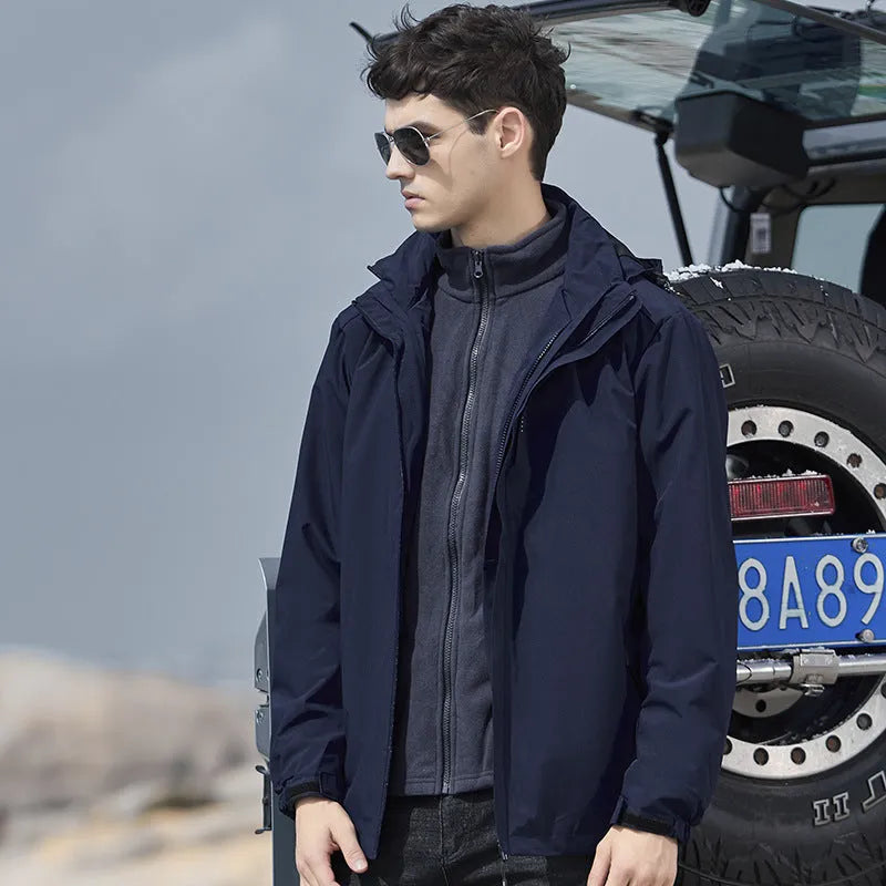 Men's black waterproof mountaineering jacket and trousers set with removable fleece lining.