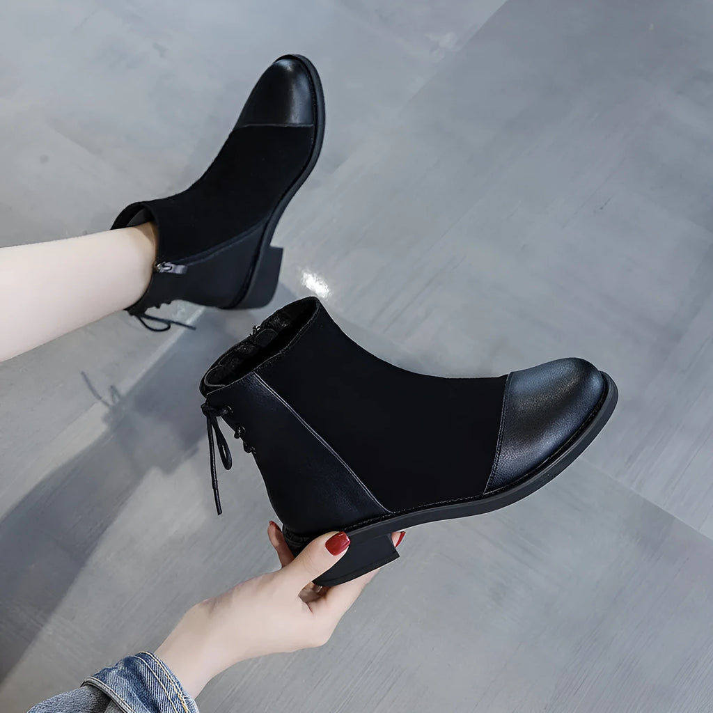Black women's over-the-knee Martin boots with side zipper and decorative bow.