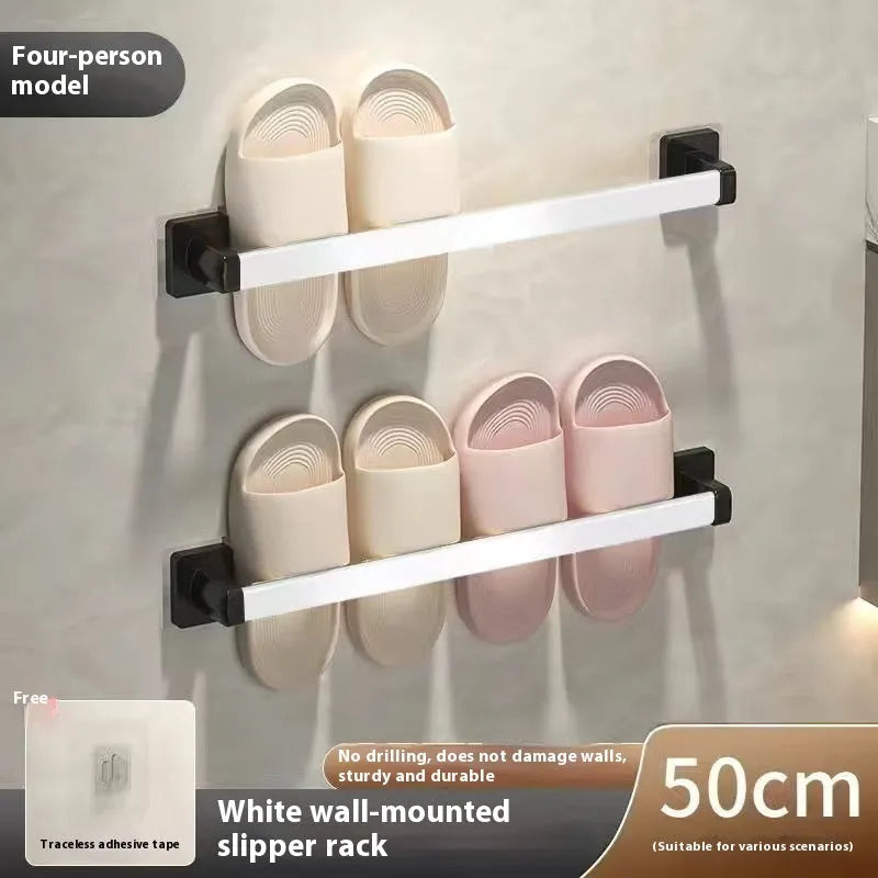 Black wall-mounted slipper rack with a small seat, shown holding two pairs of slippers.