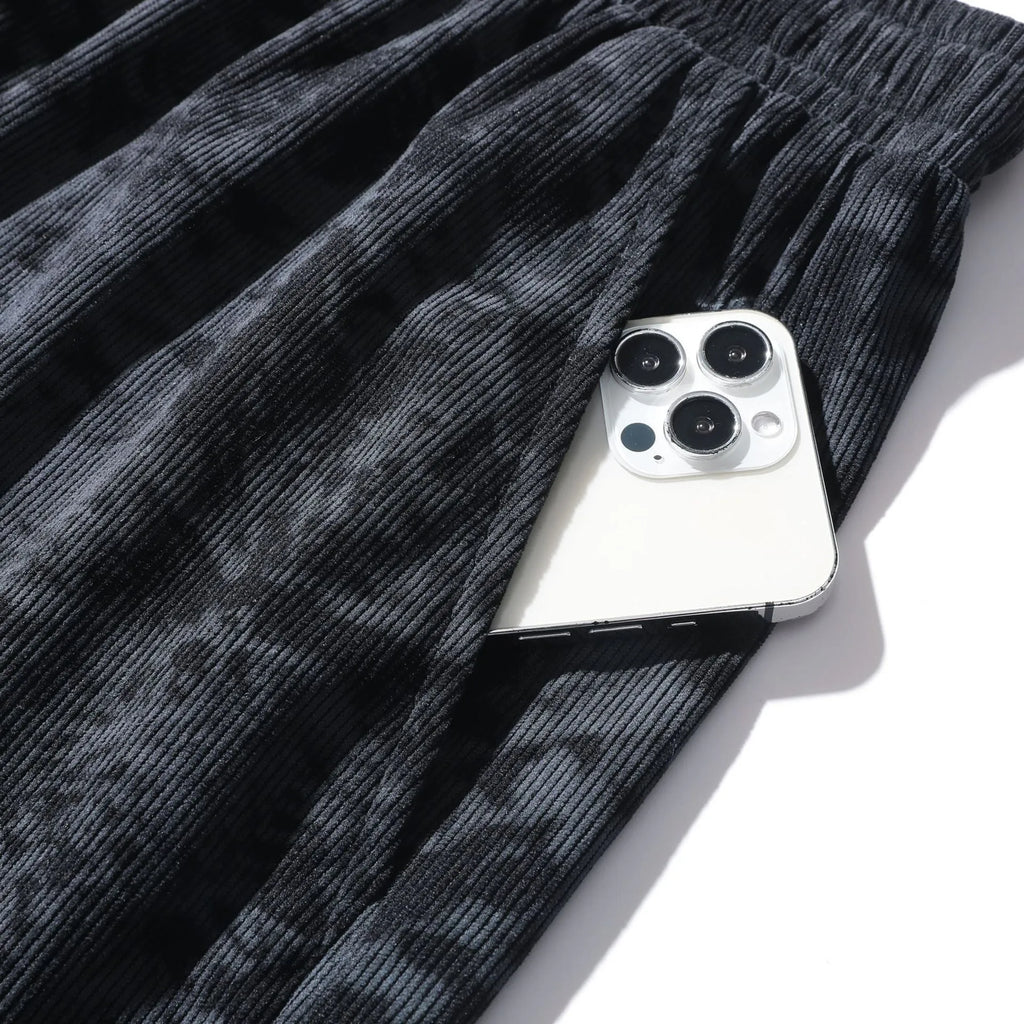 Men's straight-leg corduroy camouflage shorts in black, shown on a model.
