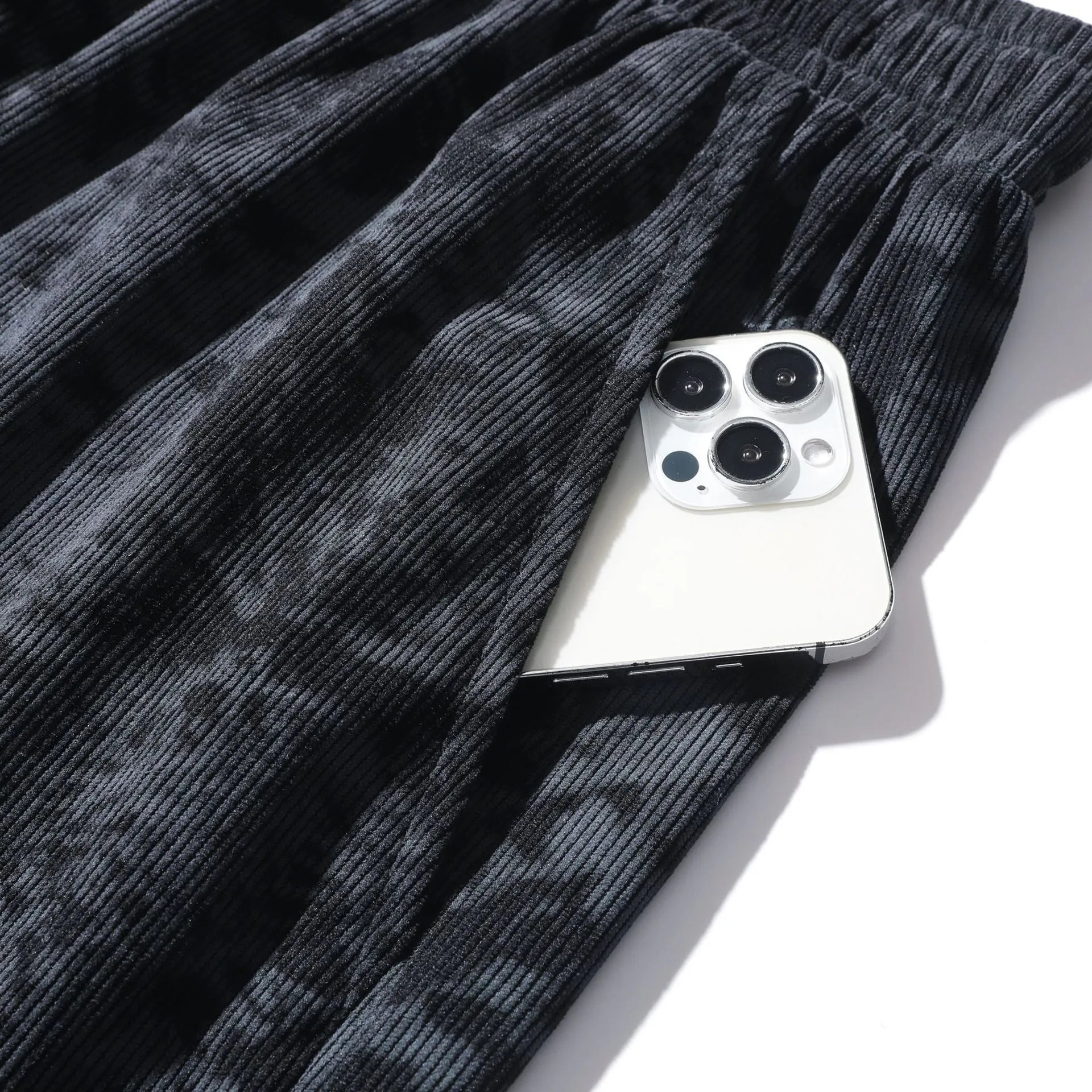 Men's straight-leg corduroy camouflage shorts in black, shown on a model.