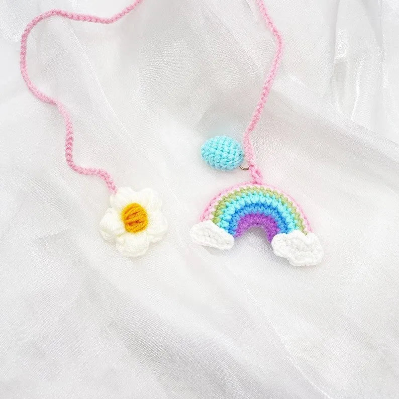 Handmade crocheted wool car pendant in avocado, pink rainbow, or red rainbow colours with cartoon styling