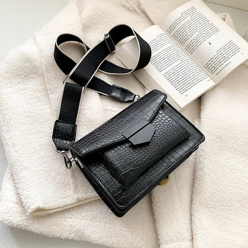 Vintage PU crossbody bag in black, shown with adjustable strap and open to reveal polyester lining.