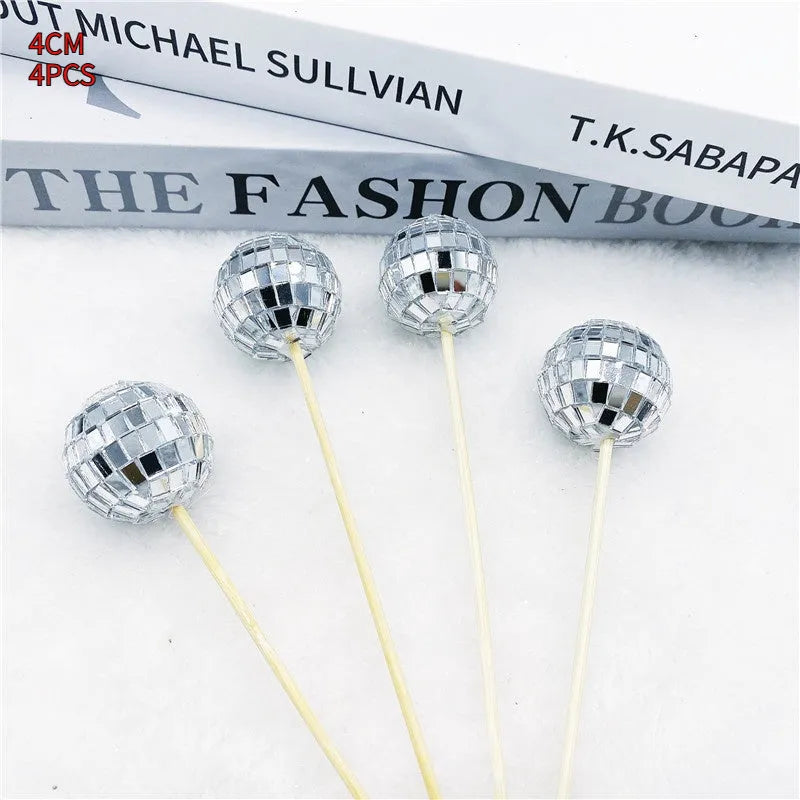 Glass disco ball cake decoration on a wooden stick, shown in different sizes for birthday cakes.