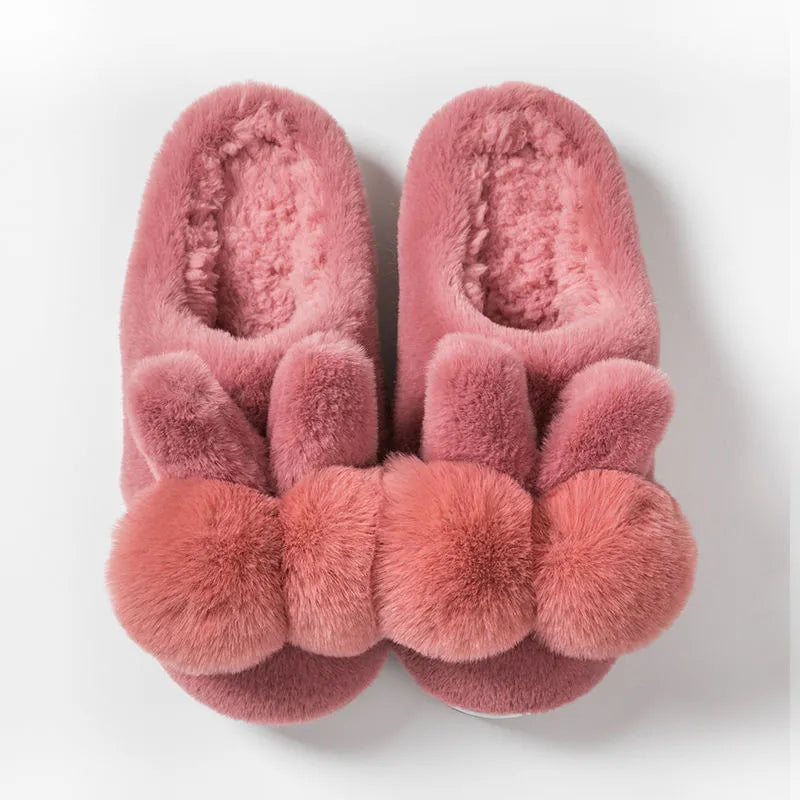 Women's fluffy bunny slippers in pink with rabbit fur, high-top sleeve design, and sewn sole.