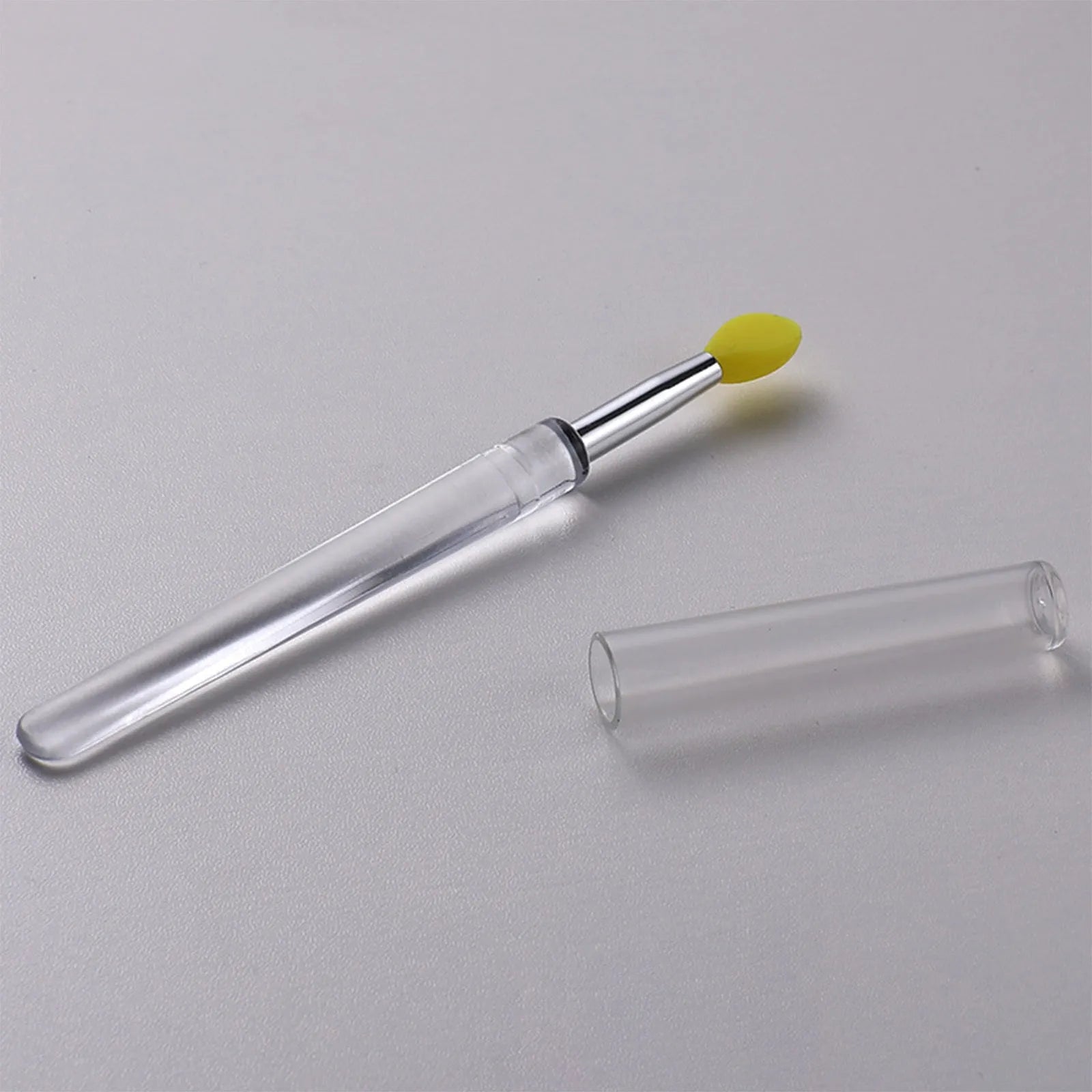 Set of silicone lip brushes with caps in various colours including blue, pink, and purple.