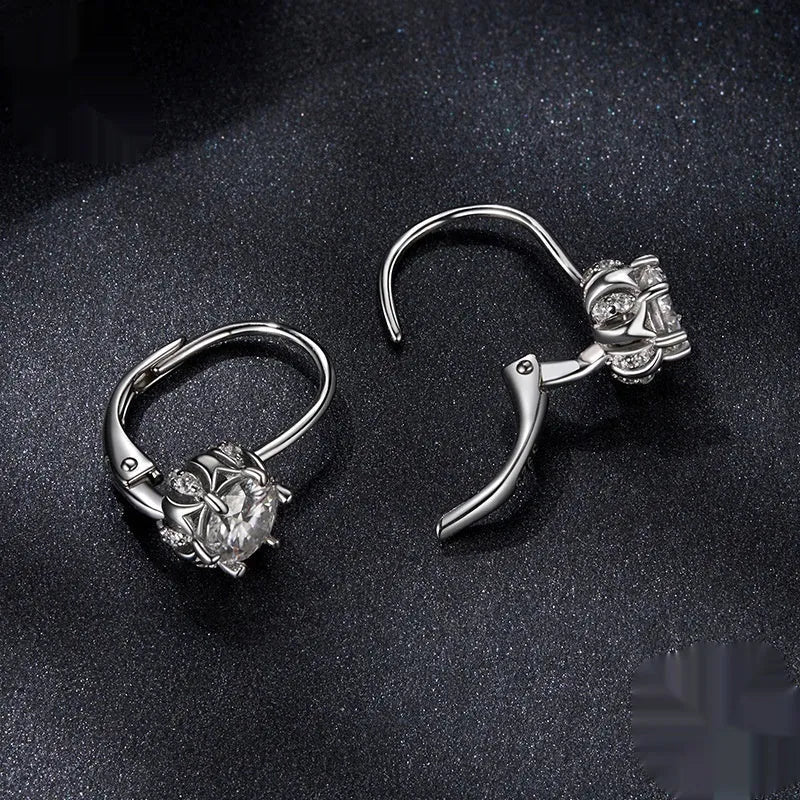 Close-up of a sterling silver flower bud clip earring with a moissanite centre, shown on a white background.