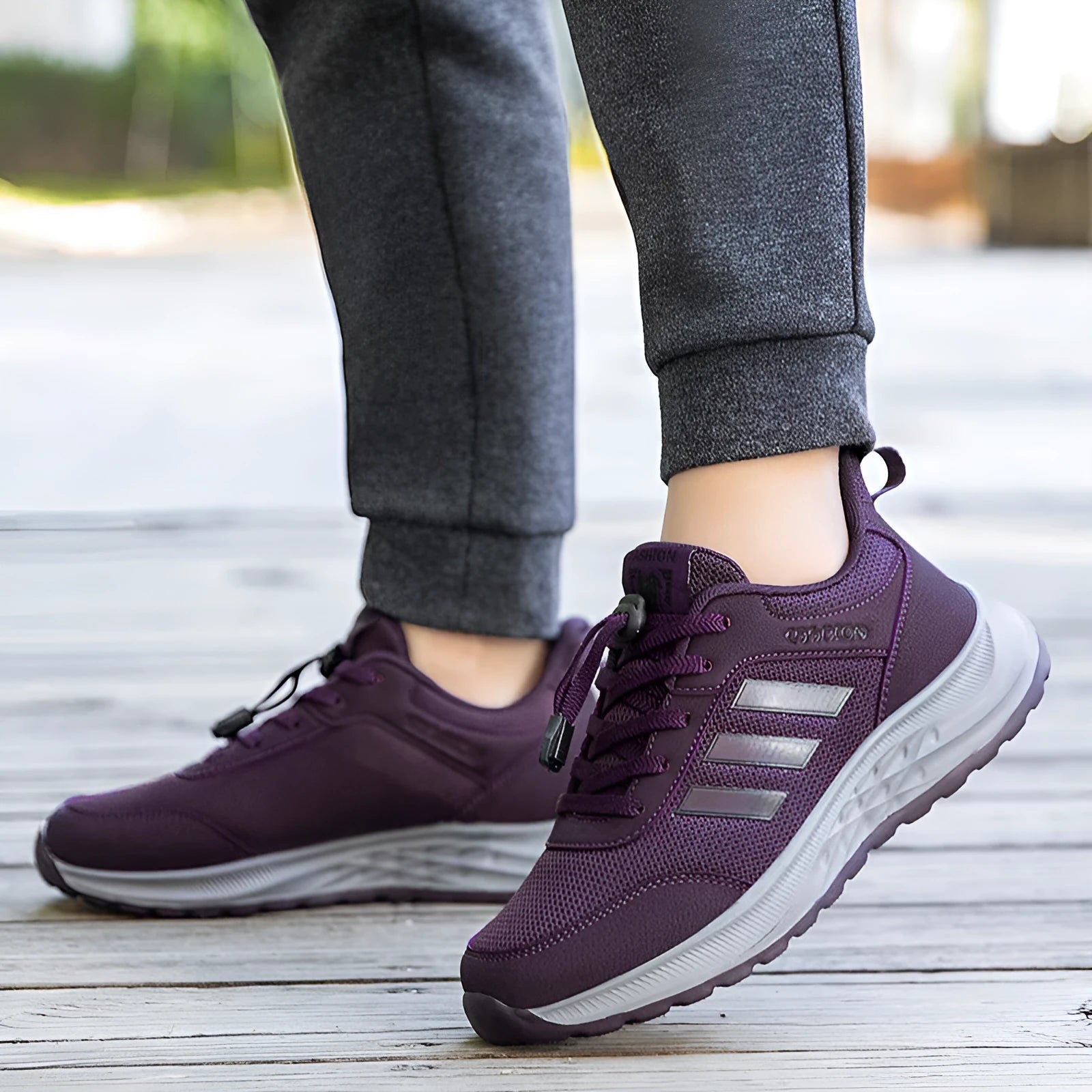 Men's and women's casual slip-on shoes with mesh upper and elastic band in black, grey, purple, and red.