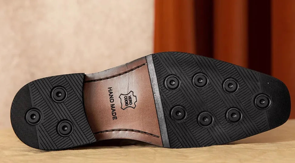 Men's brown leather loafers with fringed detail and slip-on design on rubber sole