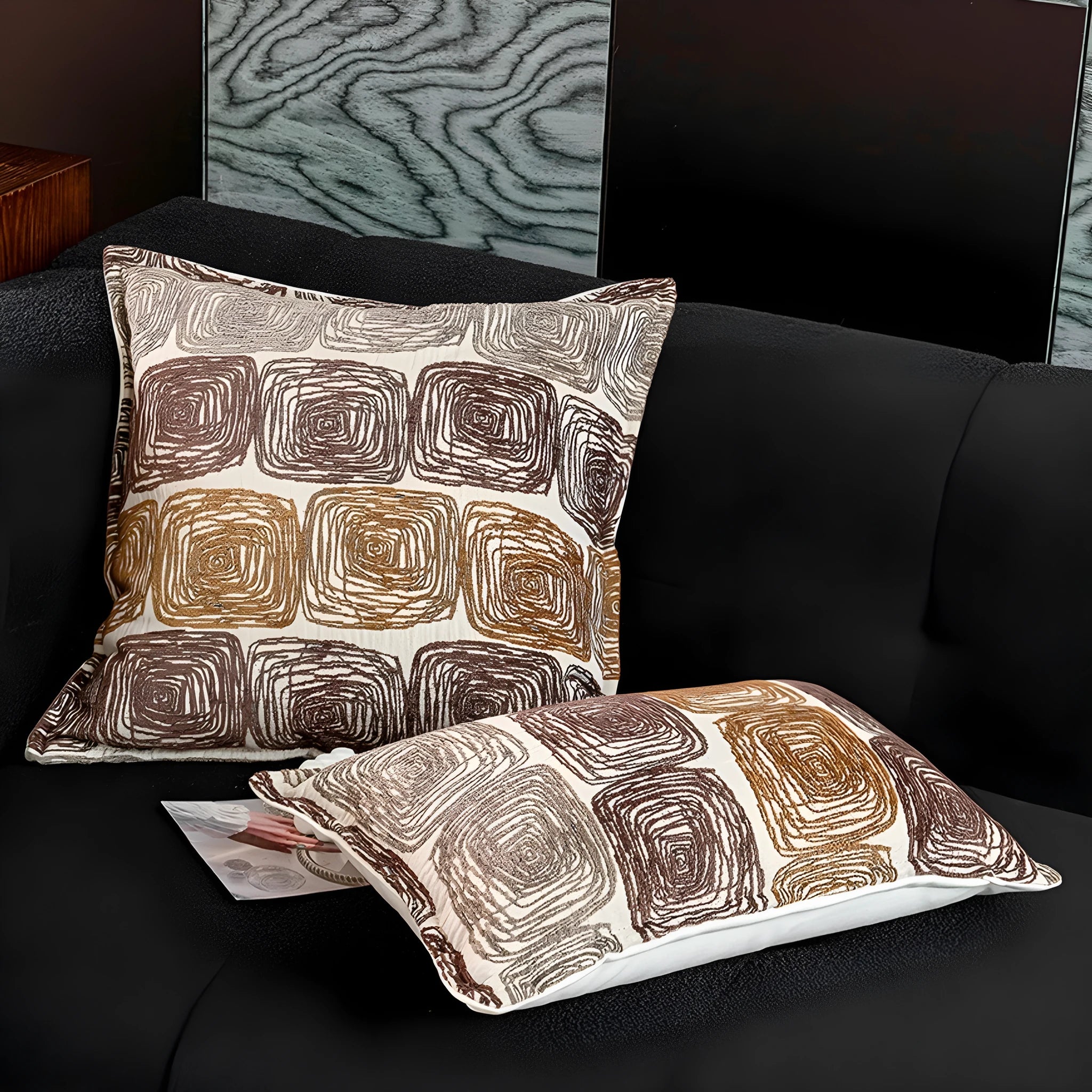 Cream and coffee-coloured abstract coil pattern on square and rectangular polyester pillow covers.