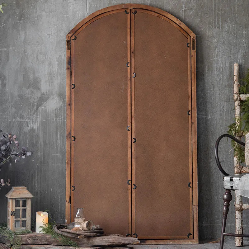 Terrace distressed wooden frame fake window wall mirror in log colour hanging on a wall.