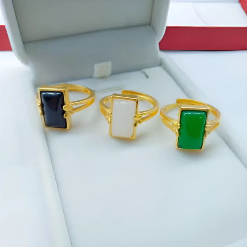 Adjustable gold-plated brass ring with a long coloured gemstone in green, white, or black.