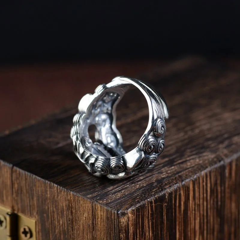 Silver open ring with detailed Jibeast zodiac animal pattern, shown on a hand.