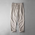 Men's casual linen trousers in a solid colour, shown in a mid-waist, full-length trouser style.