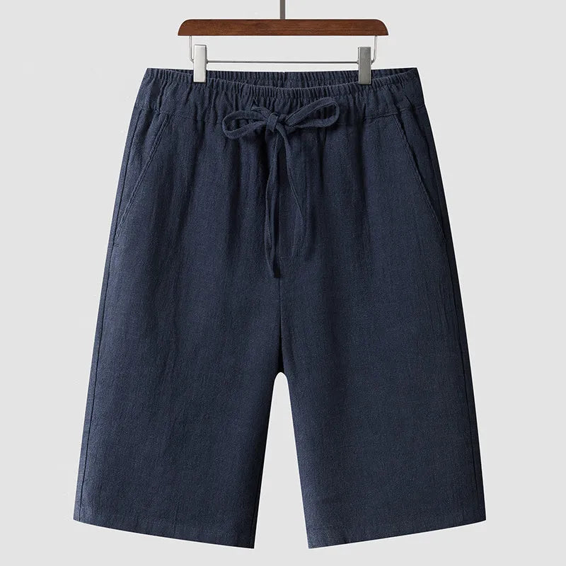 Man wearing beige linen cropped shorts with a loose fit and elasticated waist