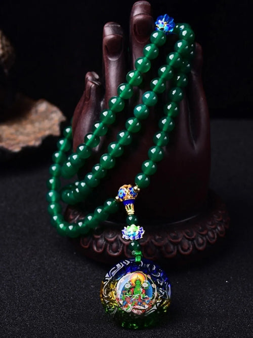 Handmade green agate bracelet with a detailed thangka pendant and multi-circle bead design.