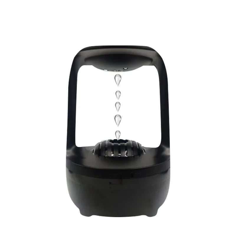 White anti-gravity water droplet humidifier with aromatherapy function on a desk.