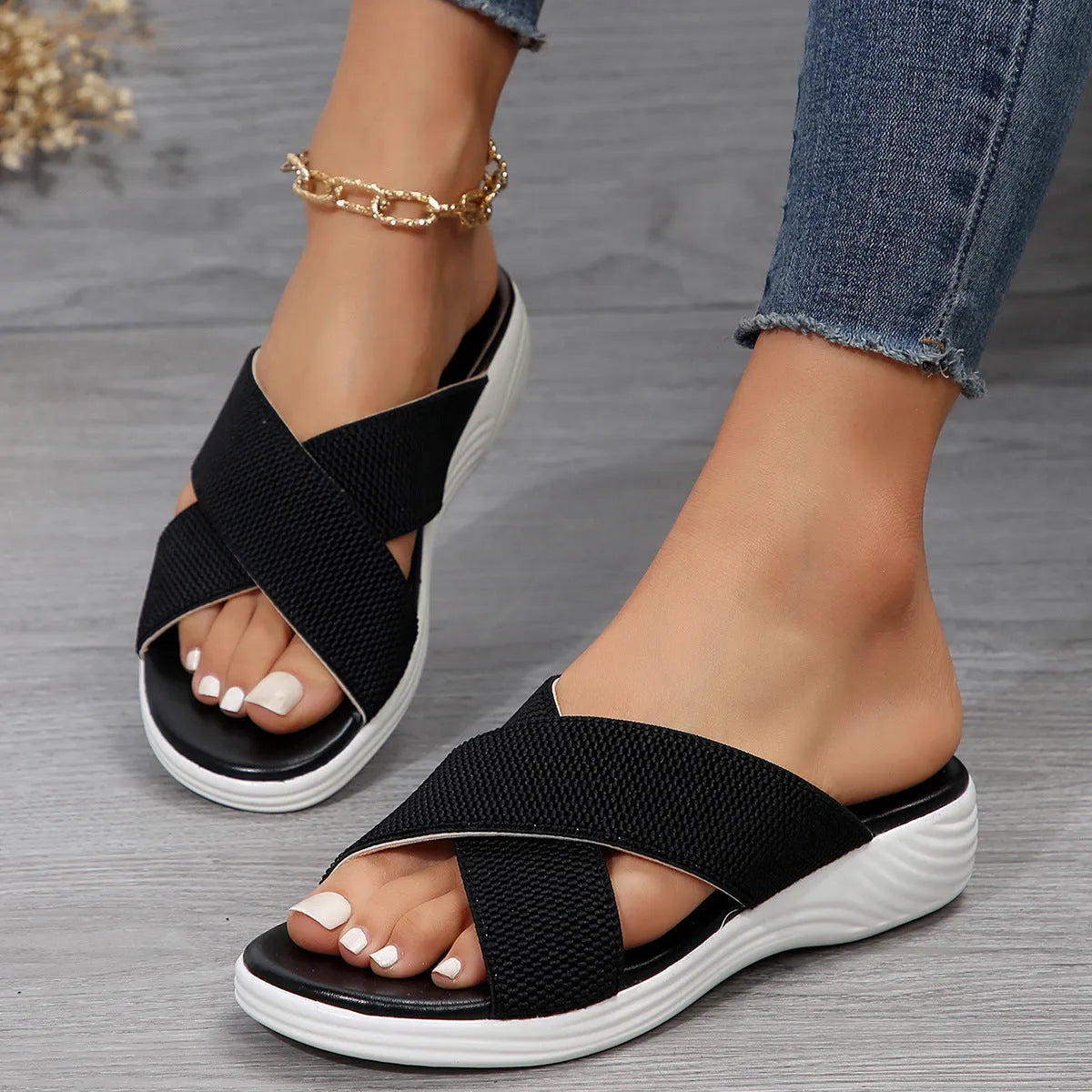 Black women's wedge heel peep-toe slippers with cross-strap design on a thick rubber sole