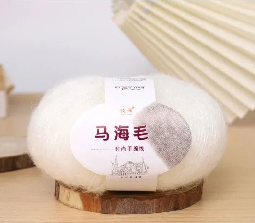 DIY mohair scarf weaving kit showing one wool ball and a selection of 34 colour options including white, pink, blue and green.