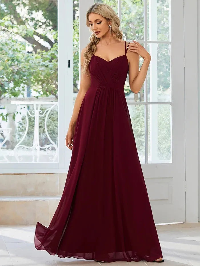 Women's long pleated sleeveless A-line dress in light green, shown on a mannequin.