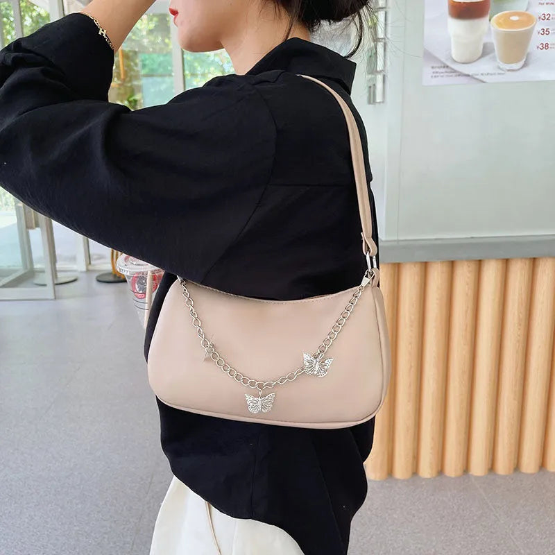 Butterfly chain crossbody bag in PU leather with a retro style, shown in light blue.