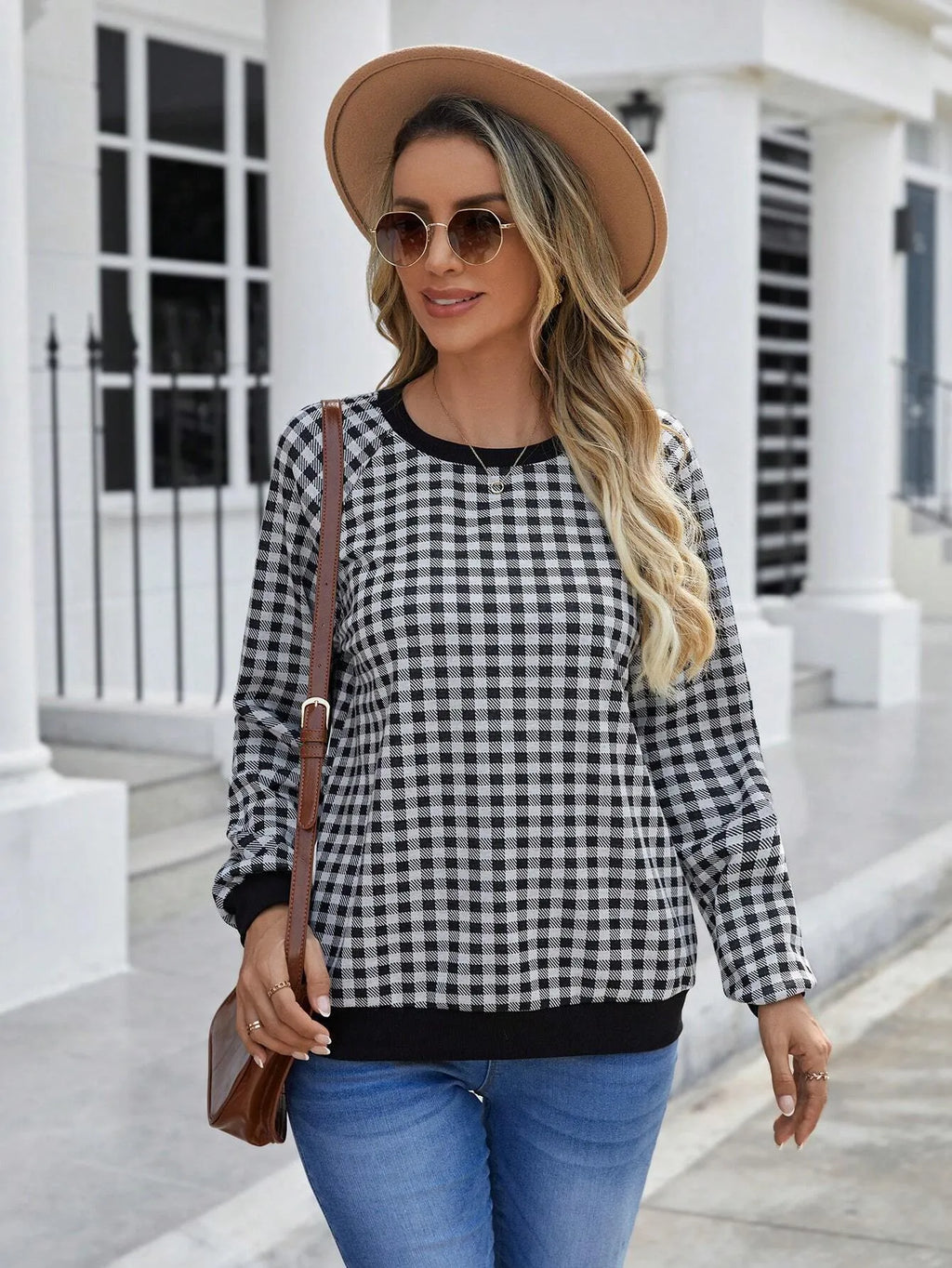 Black long sleeve pullover sweater with printed plaid and stripe pattern on a mannequin