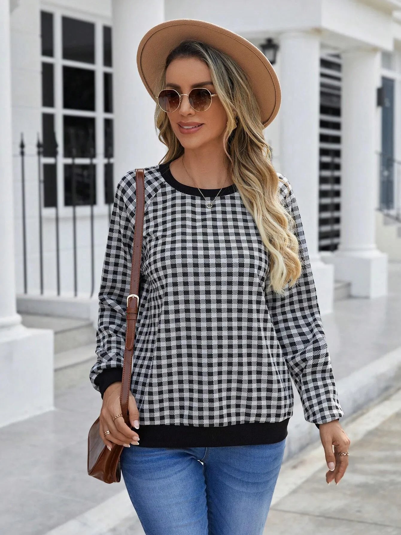 Black long sleeve pullover sweater with printed plaid and stripe pattern on a mannequin