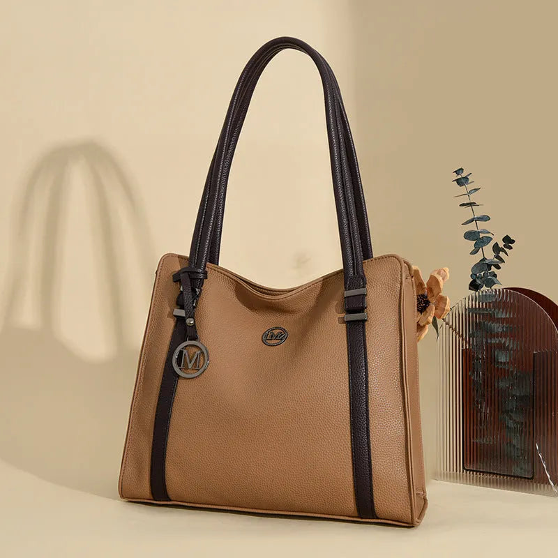 Woman holding a large soft black PU leather retro crossbody bag with double shoulder straps.