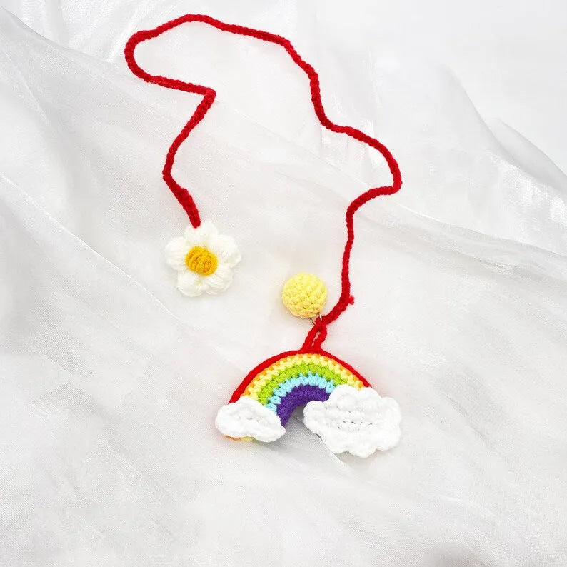 Handmade crocheted wool car pendant in avocado, pink rainbow, or red rainbow colours with cartoon styling