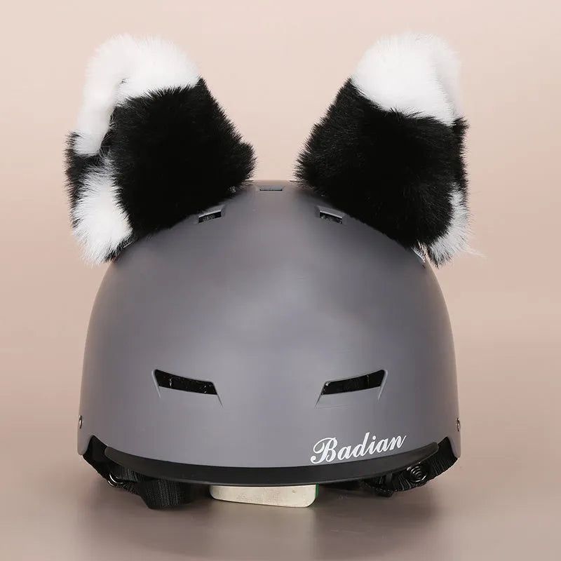 Plush fabric ski helmet decoration with cartoon design on a black ski helmet.