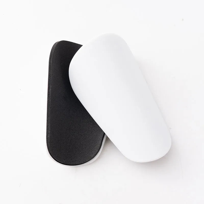 PU mini shin guards for football and sports protection in black, white, red, and blue colours.