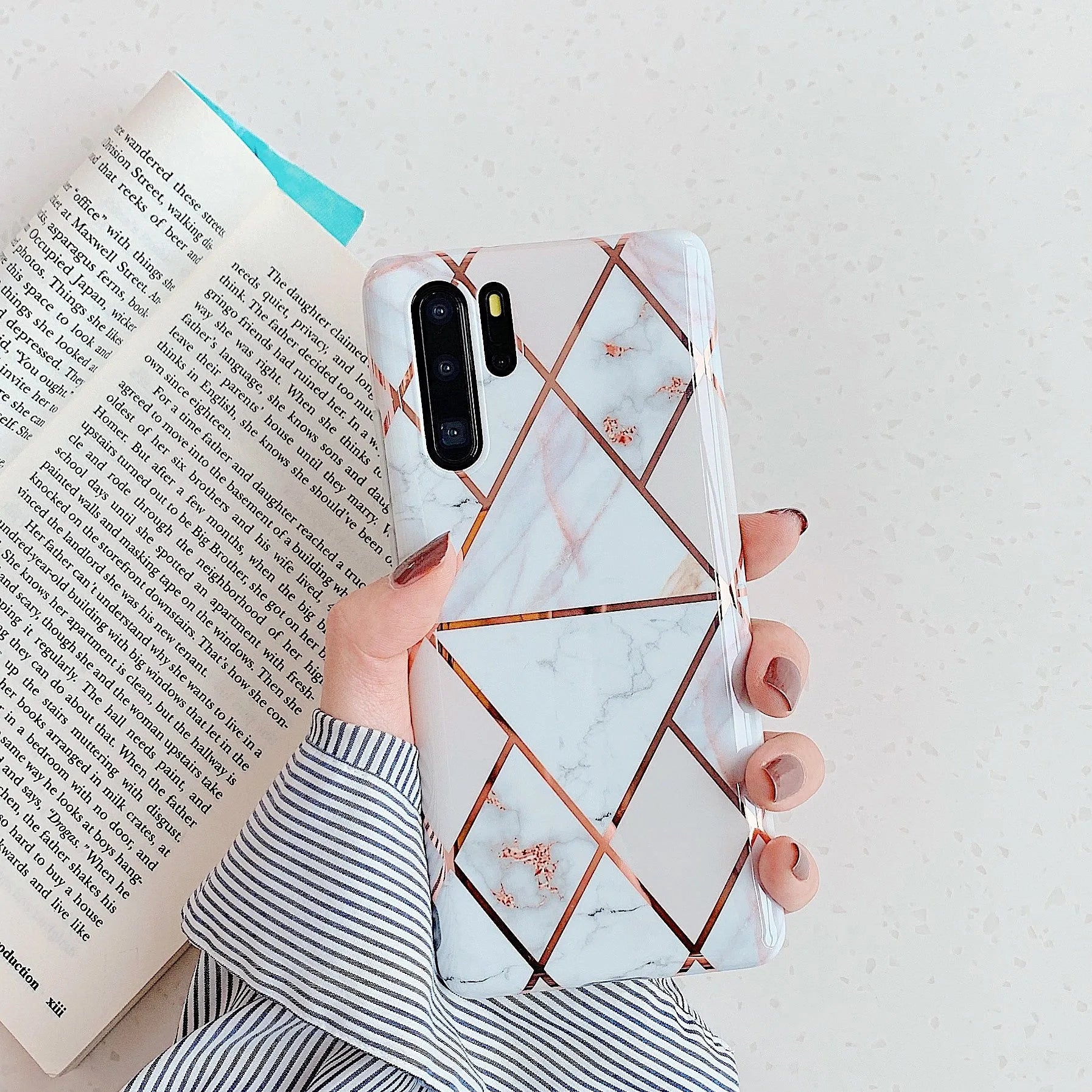 Glossy electroplated marble design TPU back cover case for a Huawei smartphone.