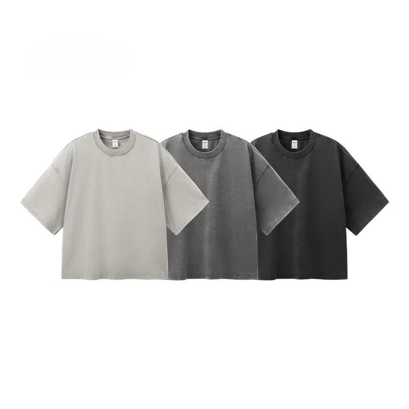 Man wearing a vintage washed khaki cotton t-shirt with loose fit and drop-shoulder sleeves.