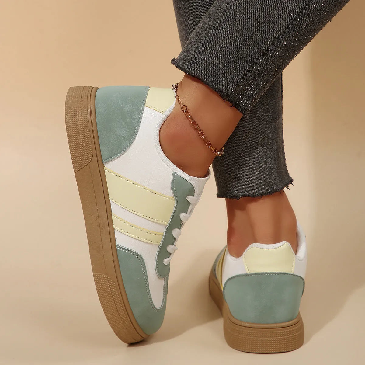 Women's green retro sports shoes with cross straps and leather stitching, low-top design with rubber sole
