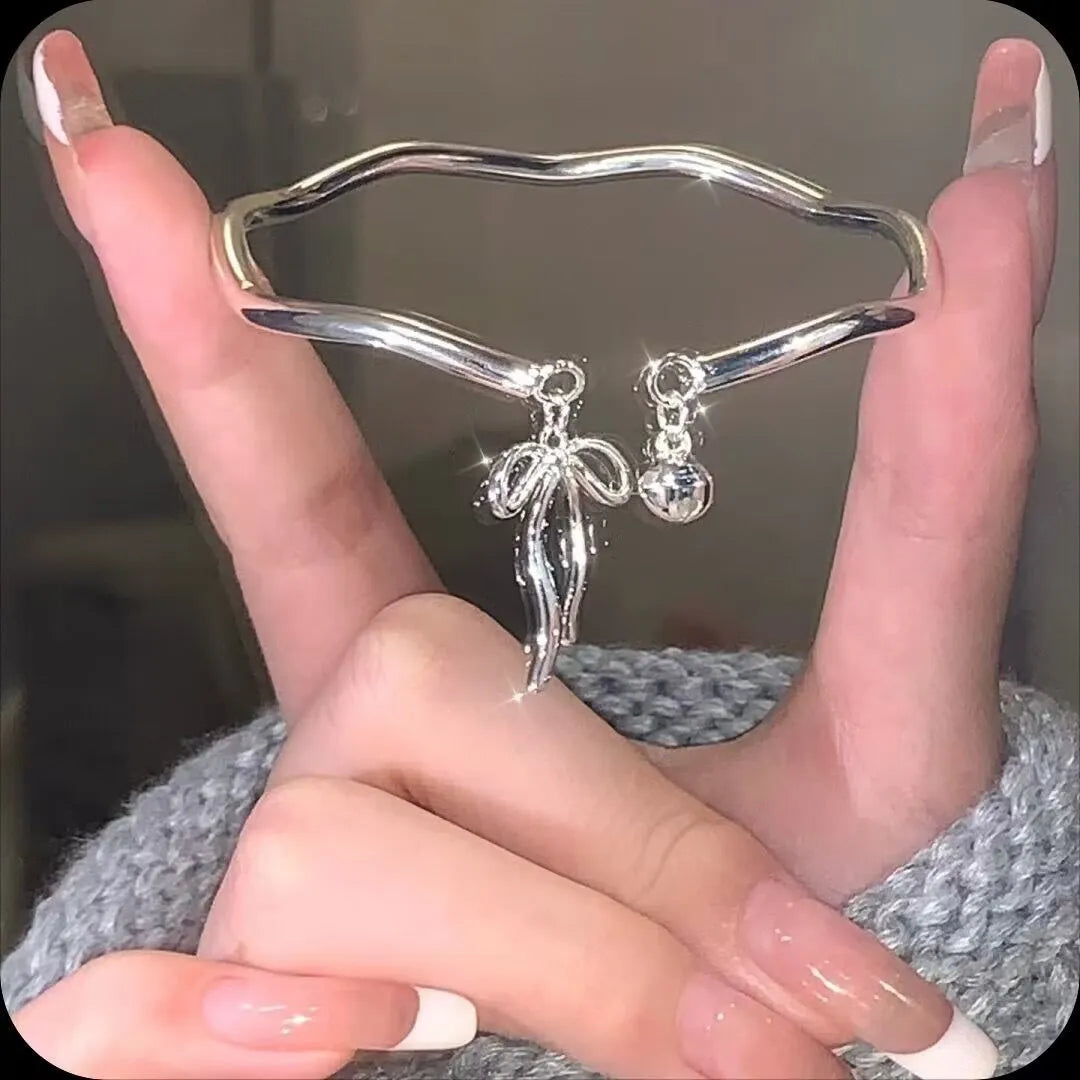 Silver bow girlfriends bracelet with adjustable bell opening clasp on zinc alloy