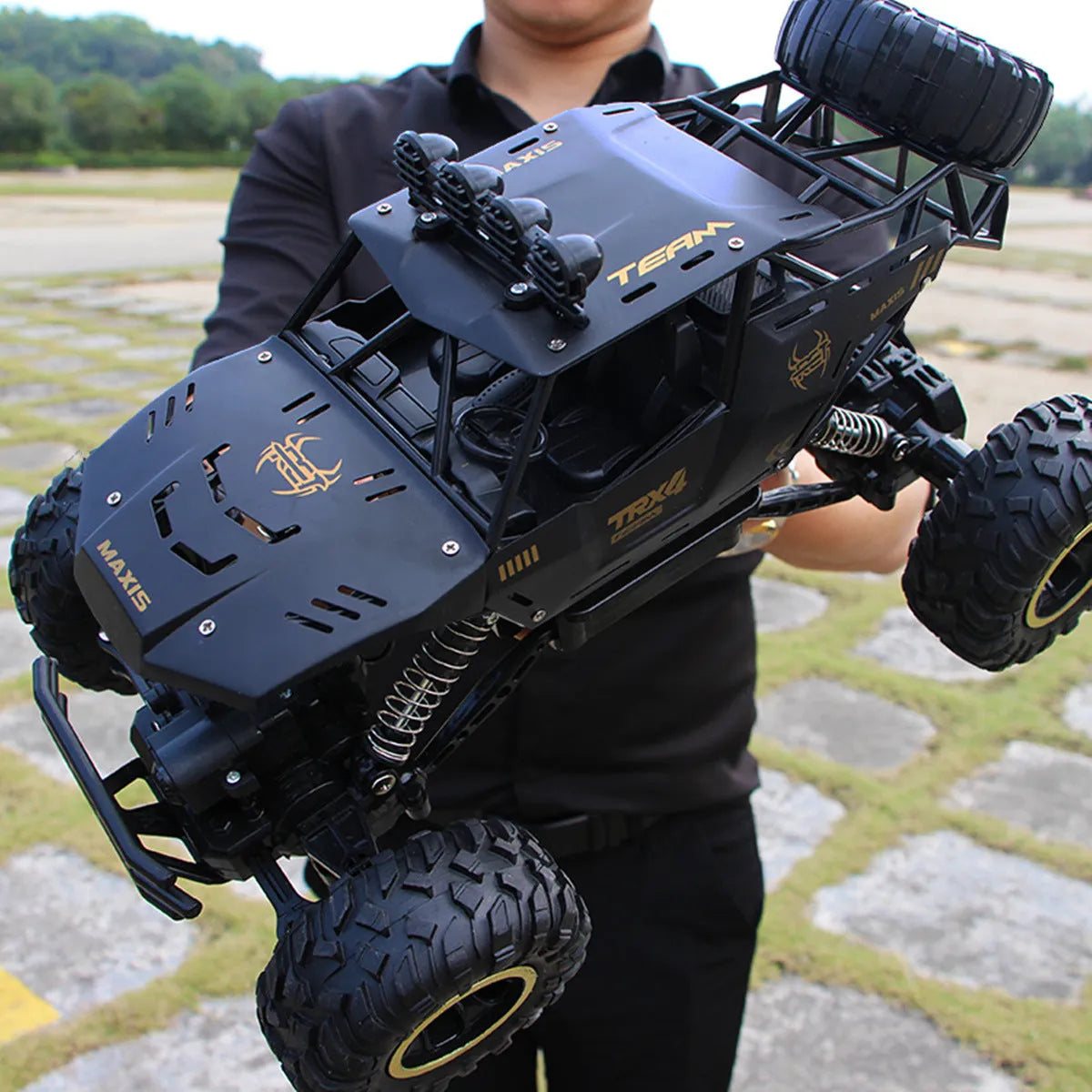 Large 4WD remote control climbing car with 2.4G wireless remote on off-road terrain