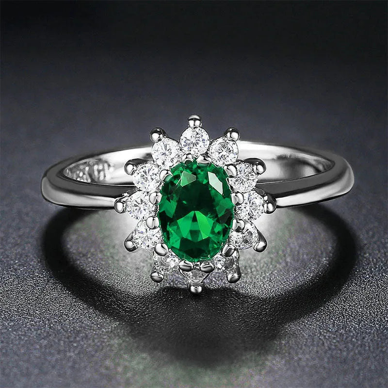Women's copper flower ring with moissanite centre, shown in green, sapphire blue, and pomegranate red colour options.